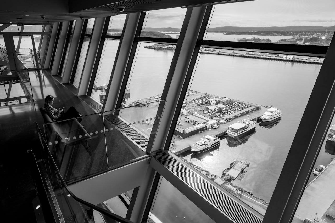 about-me-02 Black and white view of Oslo port from inside a contemporary building.